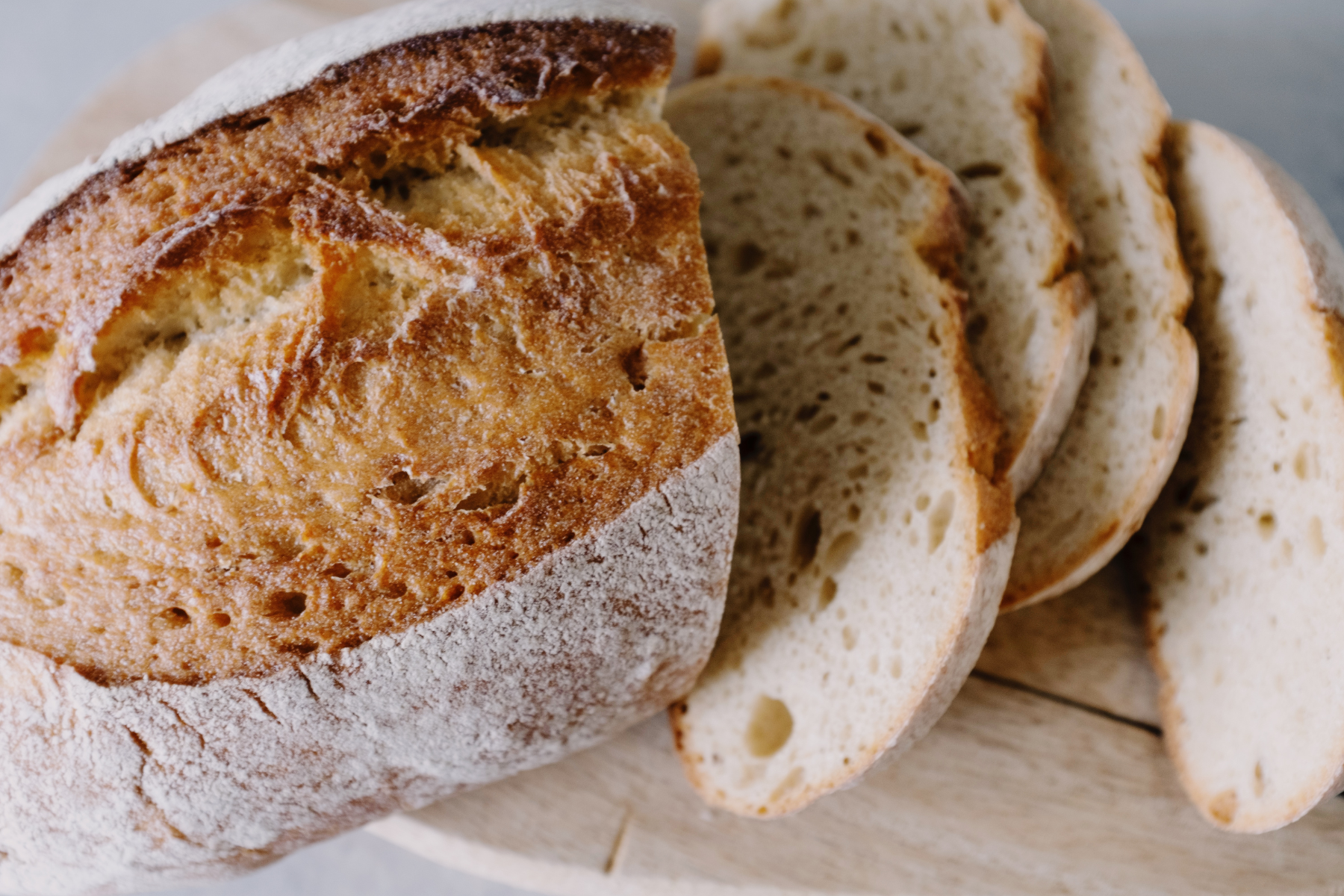 beginner sourdough bread recipe sliced loaf with open crumb